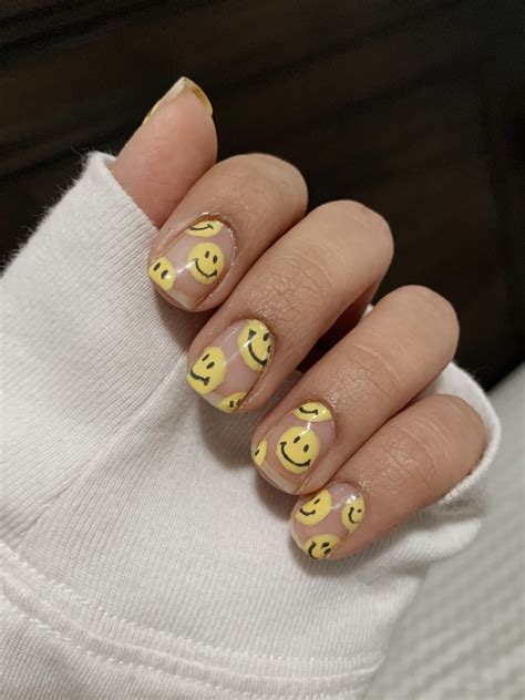 Smiley nails - Start with a solid base color (dark blue is a nice contrast with the traditional yellow smiley) and then pick two or three nails on each hand to layer up on your emoji design. Overlapping designs look the best. Then add a single smiley to your remaining nails for a coordinated look. 10.